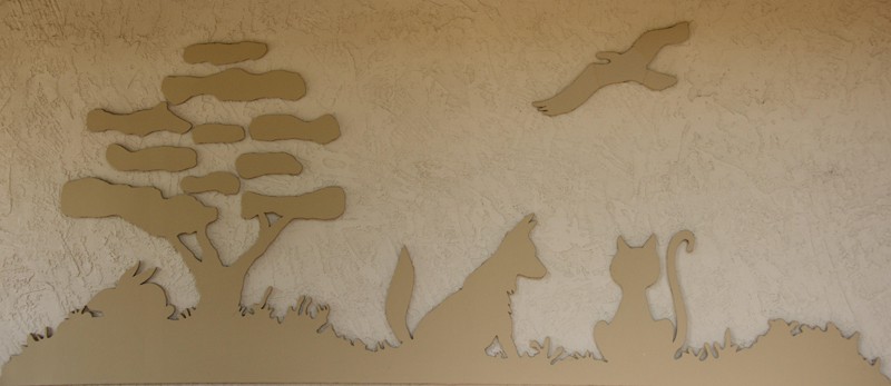 A wood cut out of the High Valley Veterinary Hospital logo
